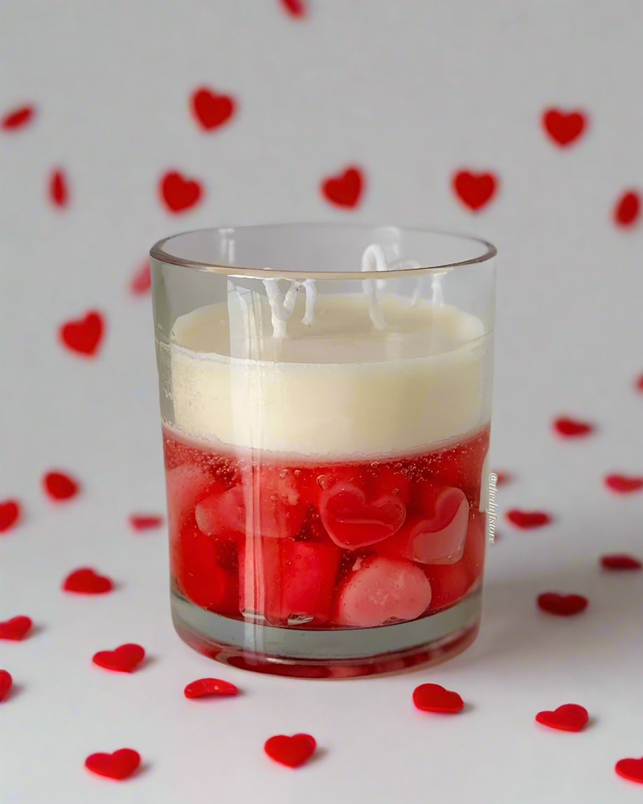 Heart-shaped glass candle with a vibrant red theme, handcrafted from pure soy wax, infused with romantic rose and sweet strawberry scents. Perfect for Valentine's Day celebrations and creating a captivating romantic ambiance.
